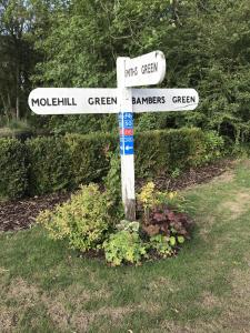 a street sign with two white street signs on it at Old Thatch Bambers Green in Takeley
