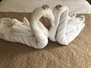 two towels sitting on top of a bed at Old Thatch Bambers Green in Takeley