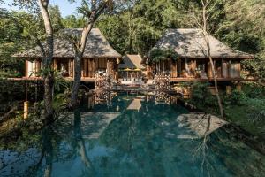 an image of a villa with a swimming pool at Four Seasons Tented Camp Golden Triangle in Golden Triangle