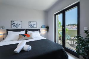 Posteľ alebo postele v izbe v ubytovaní Apartmani Vale