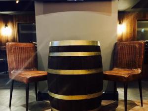 a table and two chairs in a room at Oxgang Kitchen Bar & Rooms in Grangemouth