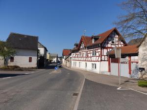 an empty street in a town with wooden buildings at Pension Zum Adler in Limbach