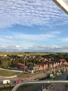 a view of a town with a river and houses at Hillrichshof in Neuharlingersiel