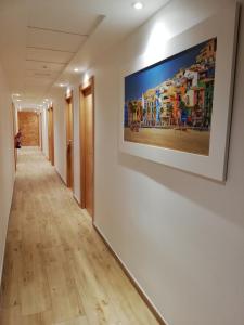 a hallway in a building with a painting on the wall at Hostal Rosa in Villajoyosa
