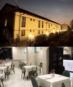 a restaurant with tables and chairs in front of a building at Hotel Rigolfo in Moncalieri