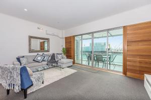 a living room with a couch and a table at Princes Wharf - Absolute Waterfront & Great Views in Auckland