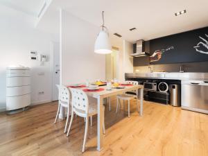 a dining room with a table and chairs in a kitchen at Flat El Porto - families only, no groups in Valencia