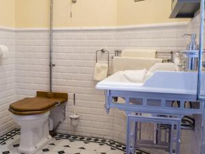a bathroom with a blue sink and a toilet at The Post House in Kinsale