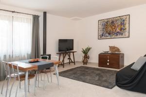 a living room with a table and a dining room at Villa Alida Casa Vacanze in Foligno