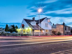 a house on the corner of a street with a traffic light at The Porterhouse in Willingham