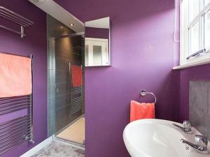 a purple bathroom with a sink and a shower at The Porterhouse in Willingham