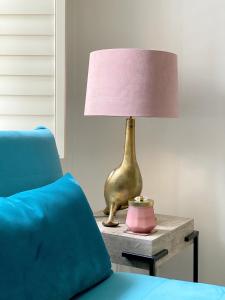a lamp on a table next to a blue couch at Price & Weeks - Heart of Bath in Bath