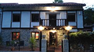 a house with a balcony with lights on it at Casa Roiz in Santillana del Mar +17 photos
