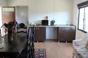 a kitchen with a table and a counter top at Quinta Pedreira dos Anjos in Provesende