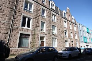 two cars parked in front of a brick building at Raeburn in Aberdeen