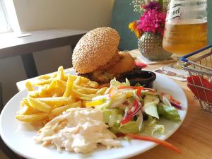 a white plate topped with a sandwich and fries at The Railway in Skipton