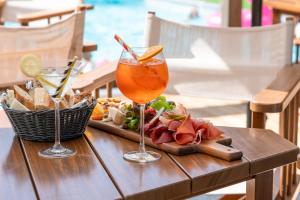 a table with a drink and a plate of food at Les Loges Blanches Megève in Megève +81 photos