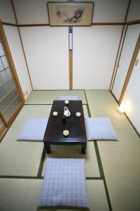 a small table in a room with three mats at Demachi 2 in Kyoto