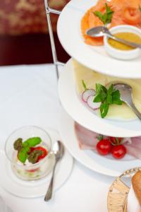 a three tiered plate of food on a table at Hotel Kaiserhof Wien in Vienna