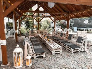 a group of lounge chairs under a pavilion at Restauracja Noclegi Ruczaj in Nowy Targ