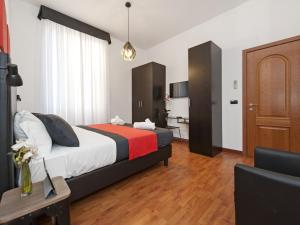 ローマにあるRetro Rooms Terminiのベッドとデスクが備わるホテルルームです。