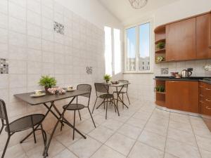 a kitchen with two tables and chairs in a room at Retro Rooms Termini in Rome