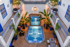 an overhead view of a swimming pool in a building with plants at Riad Sheba in Marrakesh