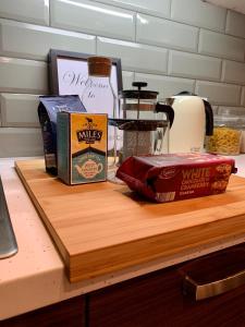 a counter with a cutting board with some food on it at Richmond House by Staytor Accommodation in Exeter