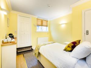 a bedroom with a white bed and a window at 1 Riverside Apartments in Norwich