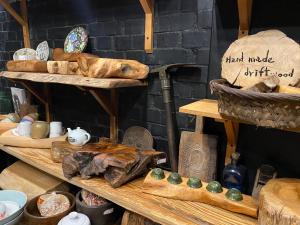 a display of different items on wooden shelves at Huatian Yilu in Xiulin