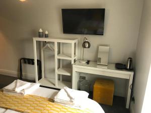 a bedroom with a bed and a tv on a wall at No.16 in Seaham