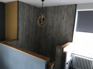 a stairway with a wooden wall and aendant light at No.16 in Seaham