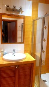 a bathroom with a sink and a shower at Apartament Karkonoska z garażem in Wrocław +16 photos