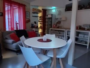 a white table and chairs in a living room at Gotland of Sweden - bed & breakfast in Tingstäde