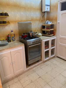 a kitchen with a stove and a counter top at Dar EL Hamra Maison Typique in Mahdia