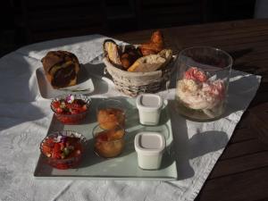 a tray of food with bread and a basket of food at Manoir du Rouvre in Mettray