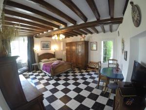 a bedroom with a bed and a checkered floor at Guest House "Près des Montgolfières" in Angé