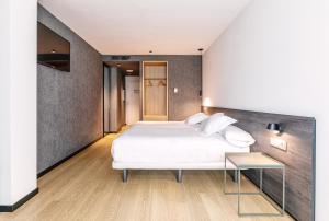 Postel nebo postele na pokoji v ubytování Hotel Forum Ceao