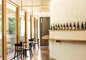 a tasting room with bottles of wine on a counter at ODELYA - Stadthotel im Park in Basel