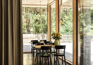 a dining room with a table and chairs and a large window at ODELYA Hotel & Naturgarten Basel City in Basel