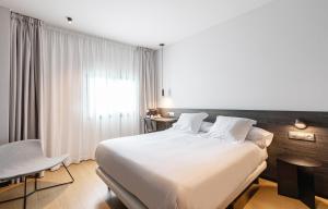 Postel nebo postele na pokoji v ubytování Hotel Forum Ceao