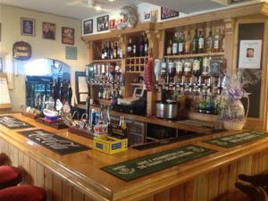 a bar with a lot of bottles of alcohol at The Safe Harbour Hotel in Fowey