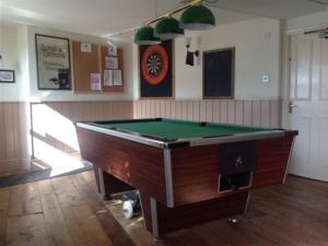 a room with a pool table in a room at The Safe Harbour Hotel in Fowey