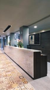 a lobby with a reception desk in a building at Panafrica Hotel Boutique & Spa in Bata +100 photos