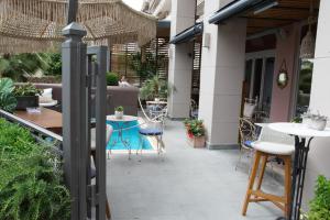 an outdoor patio with tables and chairs and a building at Marpessa Hotel & Spa in Agrinion