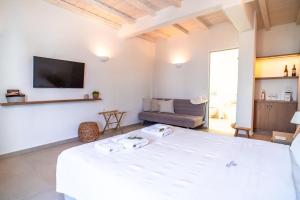 Televízia a/alebo spoločenská miestnosť v ubytovaní Vincenzo Family Rooms