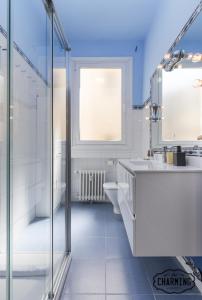 a bathroom with a shower and a sink and a toilet at Charming Gran Vía Center in Madrid