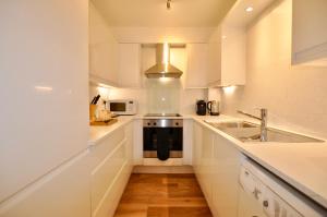 a kitchen with a sink and a stove at Marlyn Lodge – City of London in London