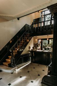 a staircase in a house with a stair case at Fiertelmeers Boutique B&B in Ronse