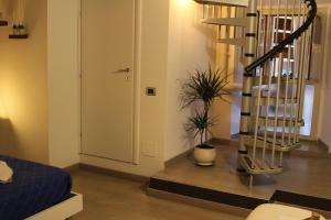 a living room with a spiral staircase next to a door at Sesta Strada in Civitavecchia